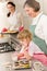 Three generations of women baking in kitchen