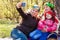 Three generations of women. Beautiful granny, mother and daughter are doing selfie and smiling while sitting on couch at home