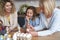 Three generations of women decorate easter eggs