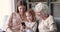 Three generations women family using phone mobile tech