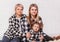 Three generations of women, grandmother, mother and granddaughter in identical clothes on a white background