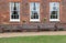 Three Georgian windows with three wooden benches