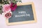 Three gerbera flowers on a writing chalkboard, text Happy Mother