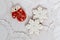 Three gingerbread cookies in the shape of red mitten and two snowflakes on a white napkin background. Top view, flat lay