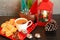 Three Gingerbread men colorful trees in wooden bowl with coffee on red dish