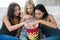 Three girlfriends eating popcorn