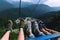 Three girlfriends in sneakers sitting in a ski lift elevator. Feet Selfie. Mountains travel concept. Krasnaya polyana Sochi Russia