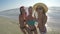 Three girlfriends taking selfie on the sandy beach