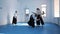 Three girls in black hakama practice Aikido