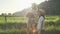 Three girls children with bouquet of flowers show finger on the road, emotions joy and happiness, wait and meet