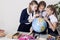 Three girls in the classroom studying geography globe of planet Earth