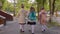 Three girls with flower bouquets walking to school, back view