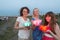 Three girls are getting ready to launch water lanterns