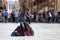 Three girls on the ground and tourists