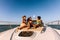 Three girls hanging out on a private yacht deck