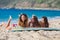 Three girls having fun on a beach with surboard