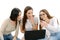 Three girls holding laptop and smart phone