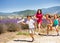 Three girls hurry after boy holding toy plane