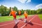 Three girls with one relay baton running