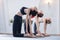 Three girls practicing yoga. Yoga instructor with her students meditating in a studio
