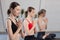 Three girls practicing yoga. Yoga instructor with her students meditating in a studio