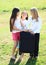 Three girls prepared for traveling with suitcase