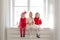 Three girls in red and white clothes window