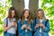 Three girls schoolgirl teen. In summer park by tree. On School change. In hands holds smartphone. The concept children