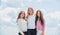 Three girls on sky background. concept of female friendship. sisterhood and family. best friends together at school