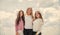 Three girls on sky background. concept of female friendship. sisterhood and family. best friends together at school