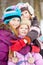 Three girls stand embracing each other in park