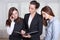 Three girls are studying the information in a folder