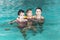 Three girls swim in the pool. Threesisters in the pool. Three happy girls play in the pool.Beautiful girls swim and having fun in