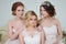 Three girls in wedding dresses. Beautiful delicate girls in the Bridal salon