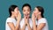 Three Girls Whispering Secret News Standing On Turquoise Background, Panorama