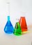 Three glass beakers filled with coloured liquid.