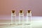 Three glass corked bottles filled with liquid. Background for science and medicine. Virus vaccine