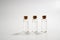 Three glass corked bottles filled with liquid. Background for science and medicine. Virus vaccine