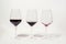Three glasses with less amount of red wine poured in each, isolated on white. Mindful drinking and alcohol cutback