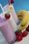 Three glasses of fresh fruit smoothie milkshake with berries and bananas