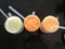 three glasses of freshly squeezed juice with tubes. Delicious, nutritious and healthy drinks