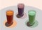 Three glasses with freshly squeezed juices on a white table