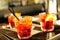 Three glasses of iced cocktails on a bar counter