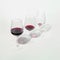 Three glasses with lowering levels of red wine poured, isolated on white. Mindful drinking and alcohol cutback
