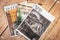 Three glossy magazines on a wooden table shot from above