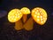 Three glossy mushrooms on the gravel in the evening, outdoor decoration