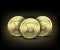 Three Gold Bitcoin on dark background.