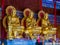 Three gold painted Chinese art Buddha statues in Thailand.