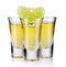 Three gold tequila shots with lime isolated on white