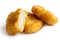 Three golden deep-fried battered chicken nuggets isolated on whi